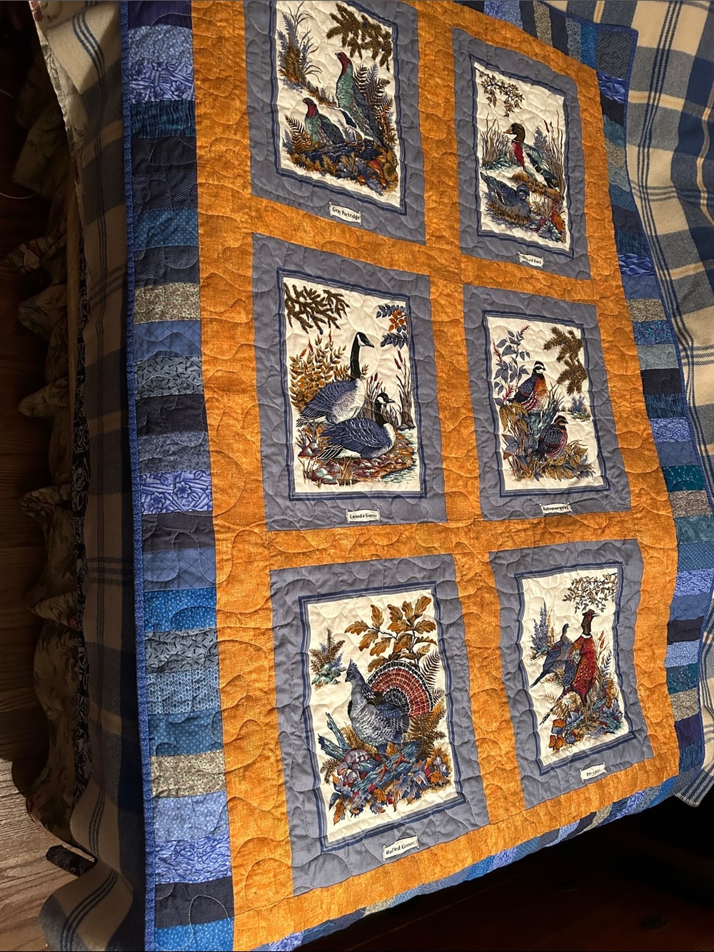 homemade patchwork quilt featuring wildlife picture panels with birds